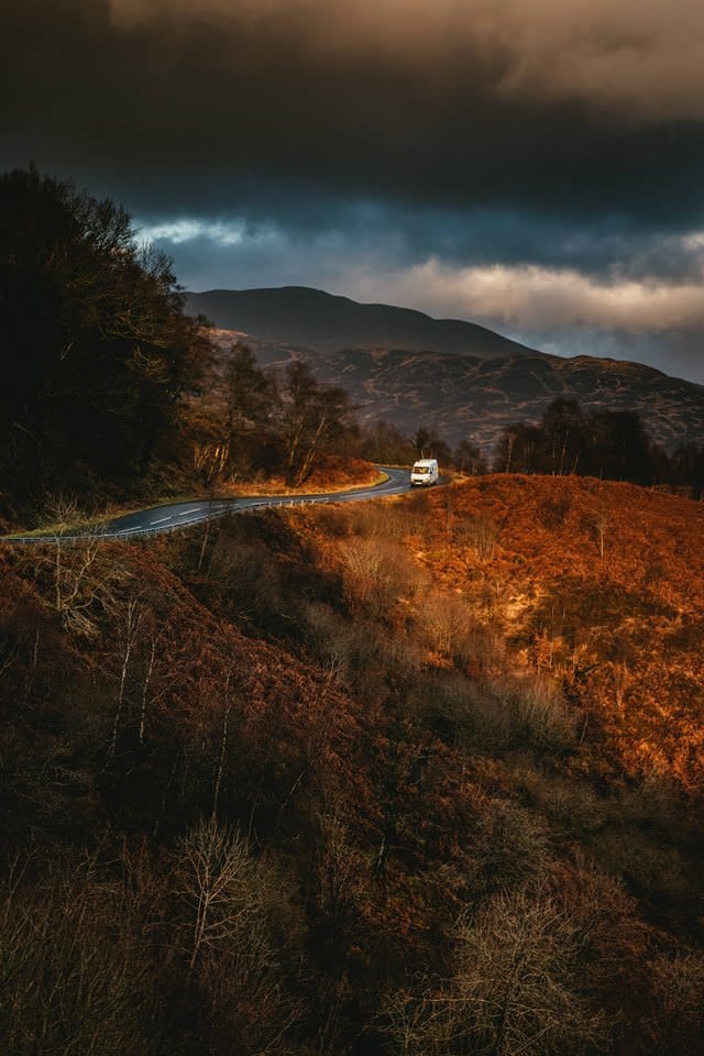 A campervan on a road in the countryside in Ireland