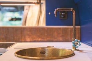 copper sink and tap for washing up in a campervan