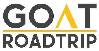 A logo with the text "GOAT ROADTRIP" in a modern, bold sans-serif font. The word "GOAT" is written in black with the 'A' stylized in yellow, resembling a mountain peak. A yellow horizontal line separates "GOAT" and "ROADTRIP," with "ROADTRIP" in black below the line.