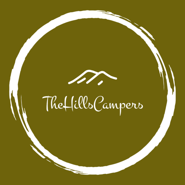 The image is a circular logo on an olive green background. The logo features a white, brushstroke-style circle enclosing a minimalist drawing of a mountain. Below the mountain drawing, the text reads "TheHillsCampers" in a white, elegant cursive font.