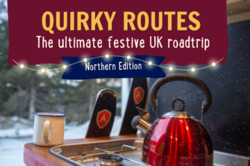 A cozy winter scene inside a camper van featuring a bright red kettle steaming on a stove. The window reveals a snowy landscape. Text on the image reads, "Quirky Routes: The ultimate festive UK roadtrip - Northern Edition," with holiday lights adorning the top.