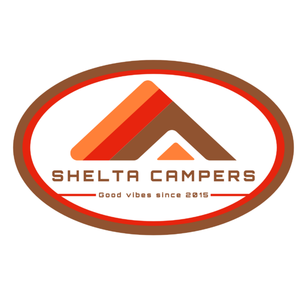 The image is a logo for "Shelta Campers." It features an abstract, triangular tent design in shades of brown and orange, set within a red and brown oval border. Below the tent graphic, the text reads "SHELTA CAMPERS" in bold, capital letters, followed by the tagline "Good vibes since 2013.