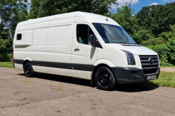 outside of the van, white, photo with a blue sky