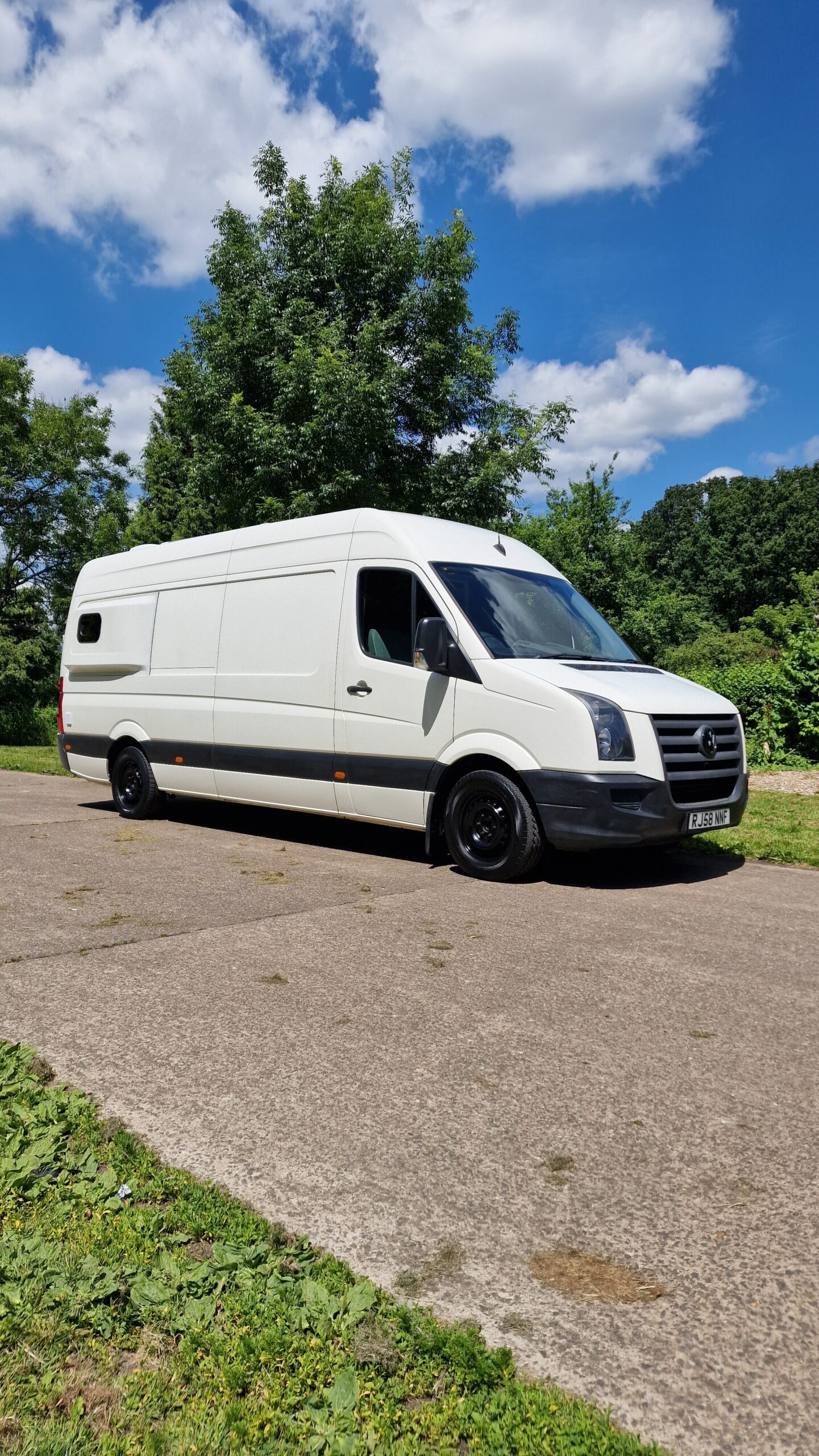 outside of the van, white, photo with a blue sky