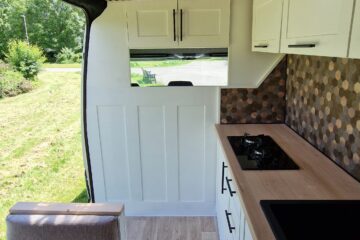 seats and kitchen set up with the sliding door open