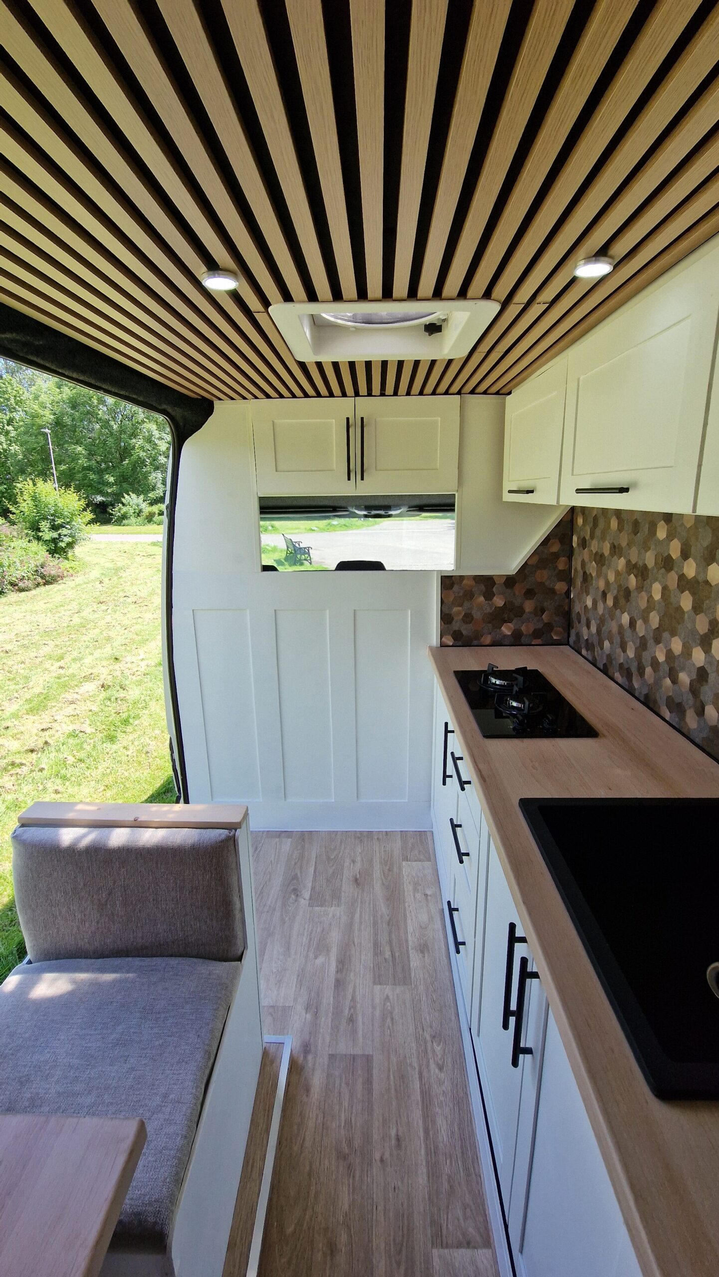 seats and kitchen set up with the sliding door open