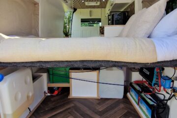 a look at the boot with the door open allowing you to see the bed and the storage space below